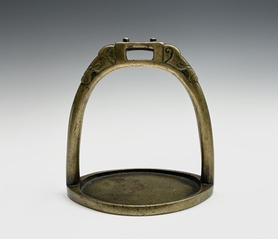 Lot 291 - A Chinese brass stirrup, Qing, with stylised...