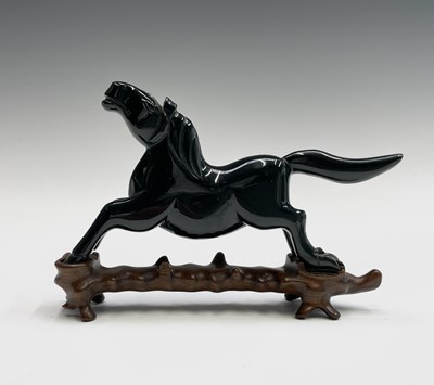 Lot 293 - A Chinese green stone figure of a horse,...