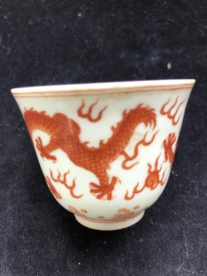 Lot 340 - A Chinese iron red dragon cup, Guangxu mark...