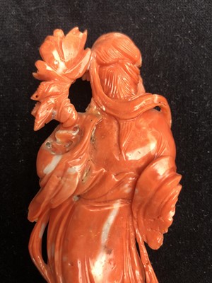 Lot 65 - A Chinese carved coral figure of Guanyin...