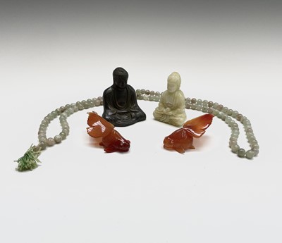 Lot 319 - A string of jade beads, of varied colour, two...