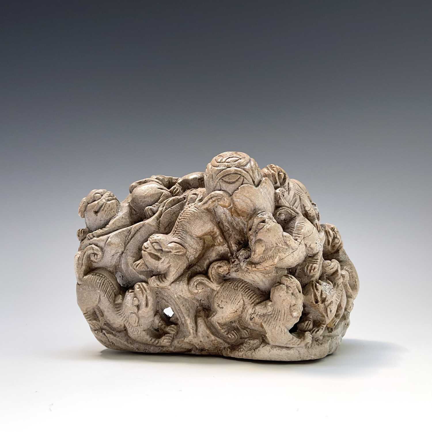 Lot 321 - A Chinese carved white stone group, circa 1900,...
