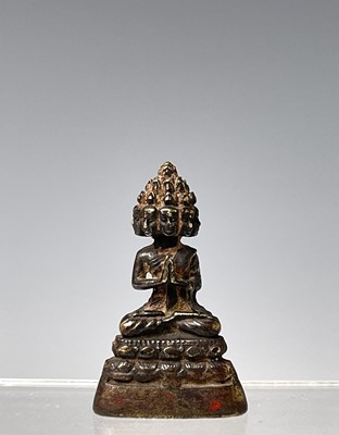 Lot 325 - A miniature bronze of a seated buddha,...