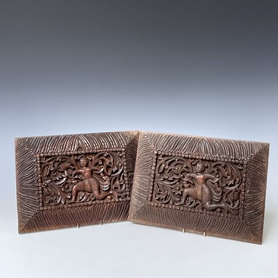 Lot 1052 - A pair of Tibetan carved wood panels, 20th...