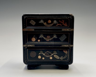 Lot 374 - A Japanese miniature black laquer chest of...