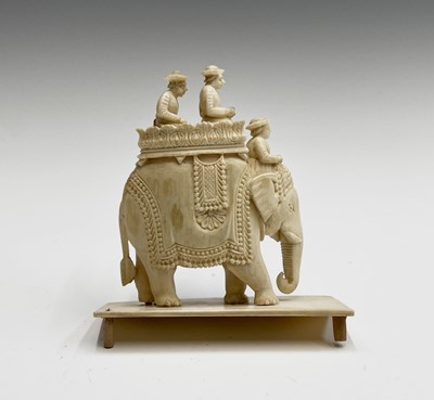 Lot 1057 - An Indian carved ivory model of an elephant,...