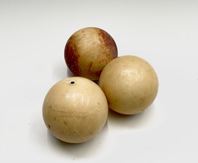 Lot 359 - Three ivory billiard balls, late 19th century,...