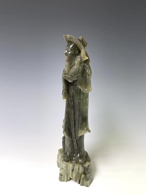 Lot 385 - A Chinese green soapstone figure, 20th century,...