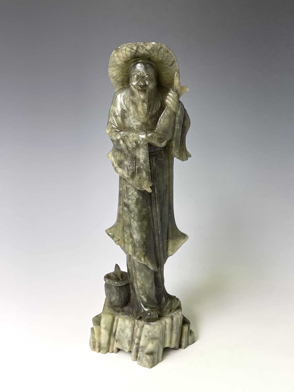 Lot 385 - A Chinese green soapstone figure, 20th century,...