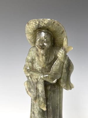 Lot 385 - A Chinese green soapstone figure, 20th century,...