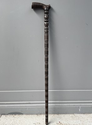 Lot 1061 - A Persian wooden sectional walking stick, 19th...