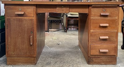 Lot 3084 - A teak pedestal desk, fitted with an...