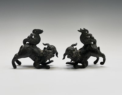 Lot 405 - Two similar Chinese bronze scroll weights,...