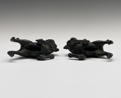 Lot 405 - Two similar Chinese bronze scroll weights,...