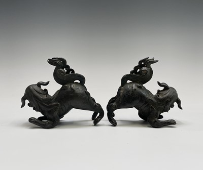 Lot 405 - Two similar Chinese bronze scroll weights,...