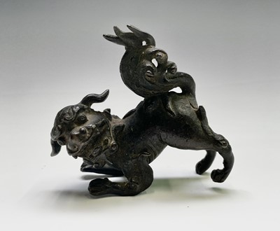 Lot 405 - Two similar Chinese bronze scroll weights,...