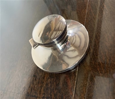 Lot 100 - An Edwardian filled silver capstan inkwell.