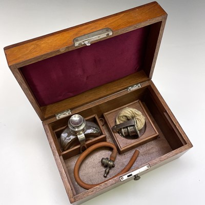 Lot 453 - A walnut cased cauterising set, probably...