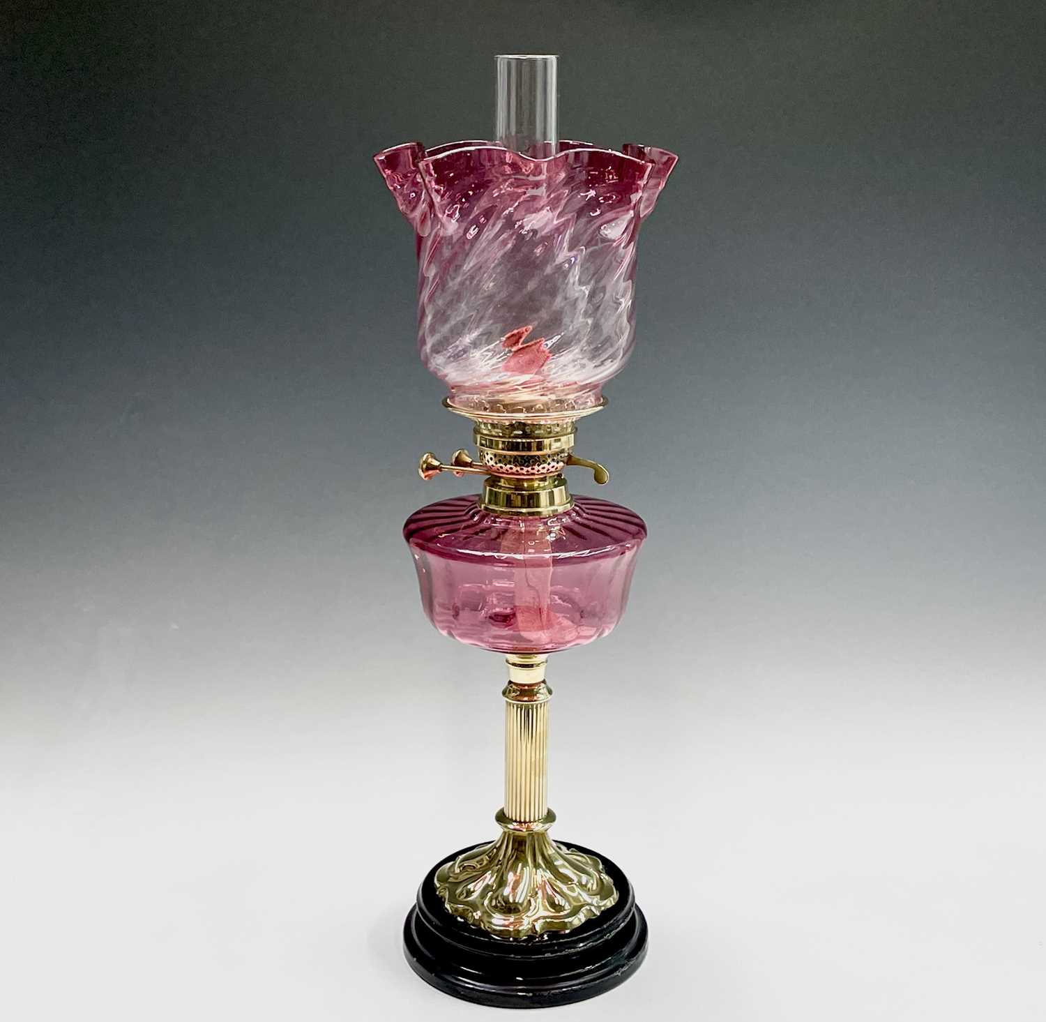 Lot 300 - A Victorian cranberry glass and brass oil lamp,...