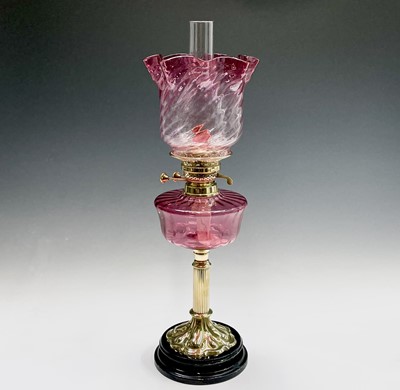 Lot 300 - A Victorian cranberry glass and brass oil lamp,...