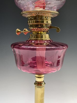 Lot 300 - A Victorian cranberry glass and brass oil lamp,...