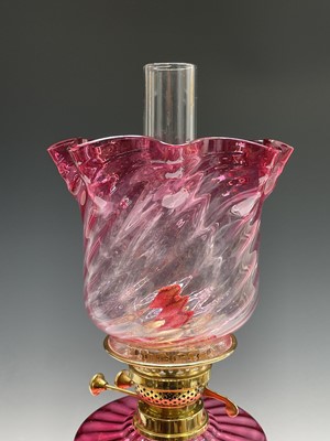 Lot 300 - A Victorian cranberry glass and brass oil lamp,...