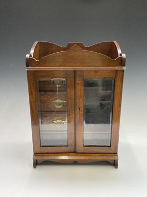 Lot 362 - An Edwardian oak two door smoker's cabinet...