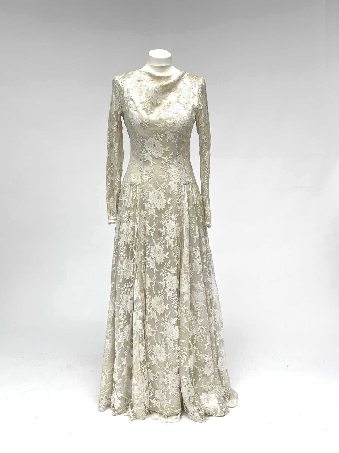 Lot 2812 - A 1950s wedding dress, duchess satin overlaid...