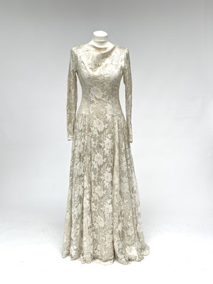 Lot 2812 - A 1950s wedding dress, duchess satin overlaid...