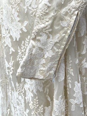 Lot 2812 - A 1950s wedding dress, duchess satin overlaid...