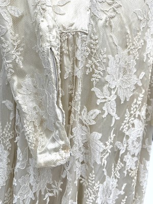 Lot 2812 - A 1950s wedding dress, duchess satin overlaid...
