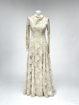 Lot 2812 - A 1950s wedding dress, duchess satin overlaid...