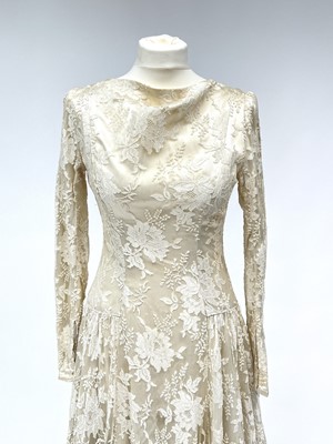 Lot 2812 - A 1950s wedding dress, duchess satin overlaid...