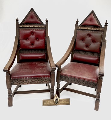 Lot 3163 - A pair of oak throne chairs, with leather...