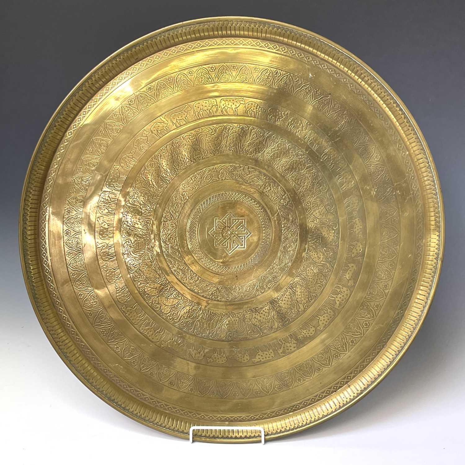 Lot 449 - An Indian circular brass tray, engraved with