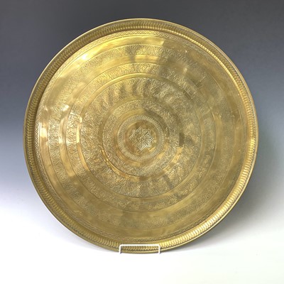 Lot 449 - An Indian circular brass tray, engraved with...