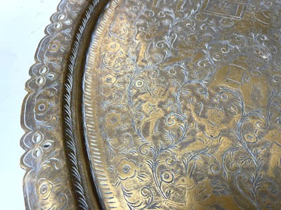 Lot 449 - An Indian circular brass tray, engraved with...