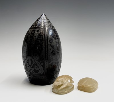 Lot 366 - An elaborately carved African nut, height...