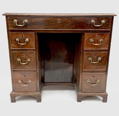 Lot 3185 - A George III mahogany kneehole desk, with a...