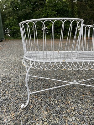 Lot 629 - A wrought iron garden love seat, width 116cm.