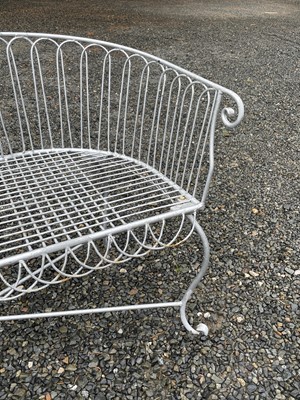 Lot 629 - A wrought iron garden love seat, width 116cm.