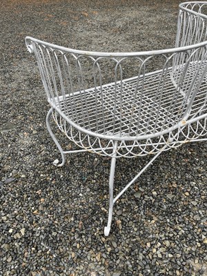 Lot 629 - A wrought iron garden love seat, width 116cm.