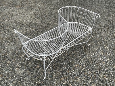 Lot 629 - A wrought iron garden love seat, width 116cm.