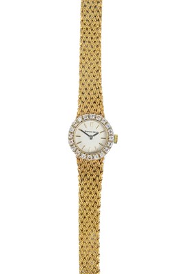 Lot 101 - A Bueche-Girod 9ct gold lady's manual wind bracelet wristwatch with diamond-set bezel.