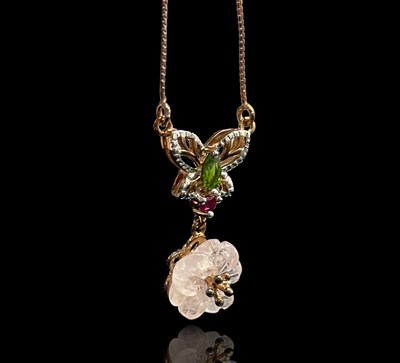 Lot 184 - A butterfly and flowerhead pendant set with...