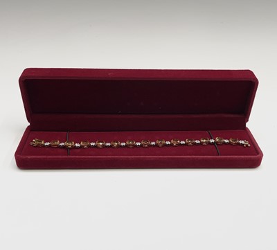 A 10ct gold bracelet with diamond centered...
