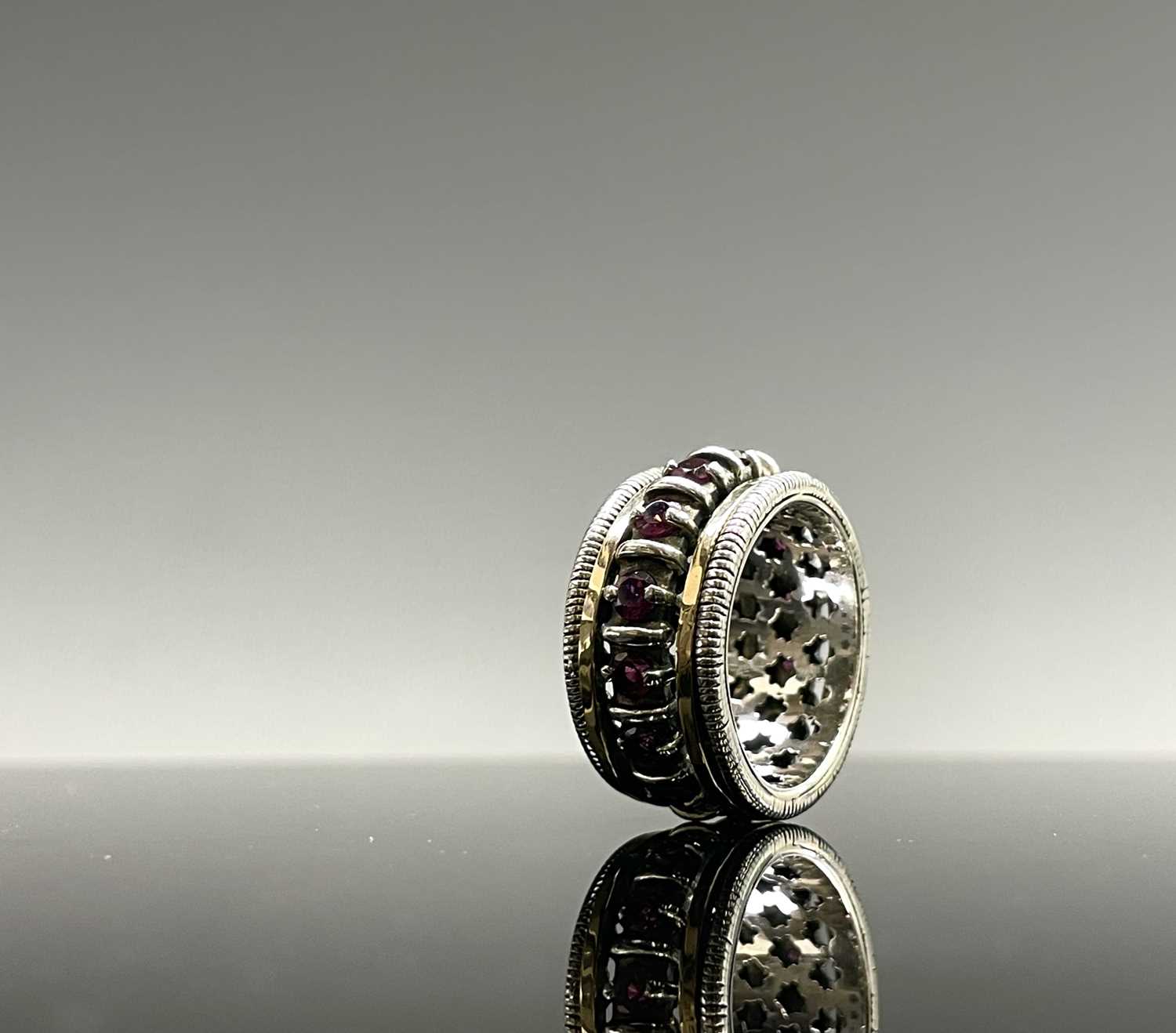 Lot 261 - A contemporary silver ring with a gold bands...