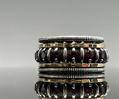 Lot 261 - A contemporary silver ring with a gold bands...