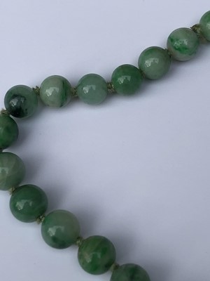 Lot 220 - A Chinese jade necklace, with graduated beads,...