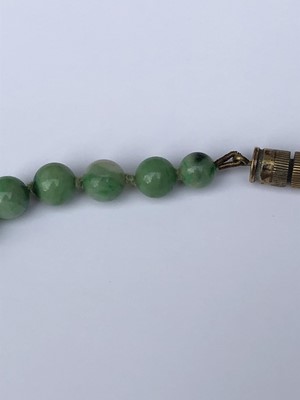 Lot 220 - A Chinese jade necklace, with graduated beads,...